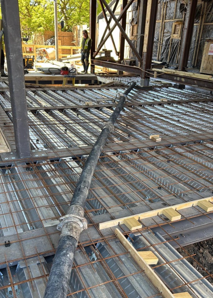 A King Concrete Pumping line pump feeding concrete on site near Gatwick